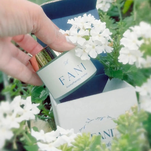 Hand holding box of FANI aromatherapy product by araam wellness