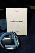 Load image into Gallery viewer, araam muslim girl wellness gathering — Araam Gala (Dallas) — meditation booth with headphones from the Araam meditation app, July 20, 2025
